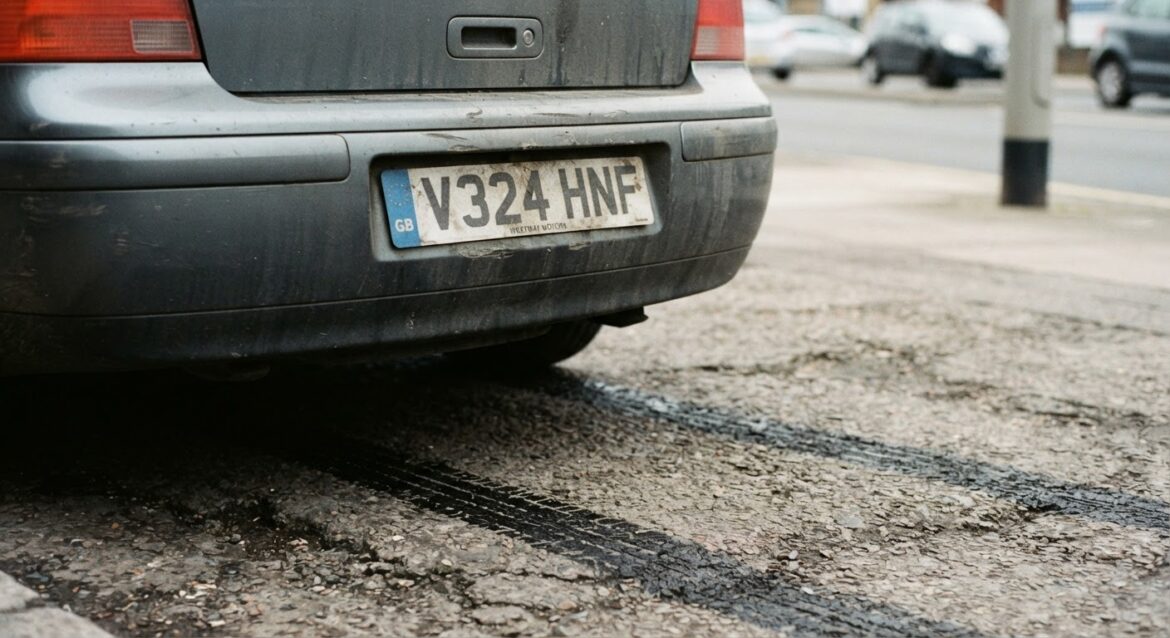 close-up of a car license plate and skid marks on pavement
